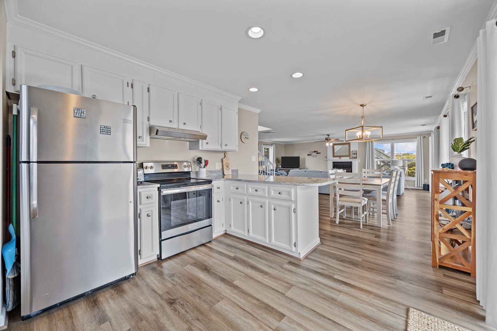 Your spacious kitchen features gleaming stainless steel appliances, crisp white cabinetry, and a generous island perfect for cooking meals together.