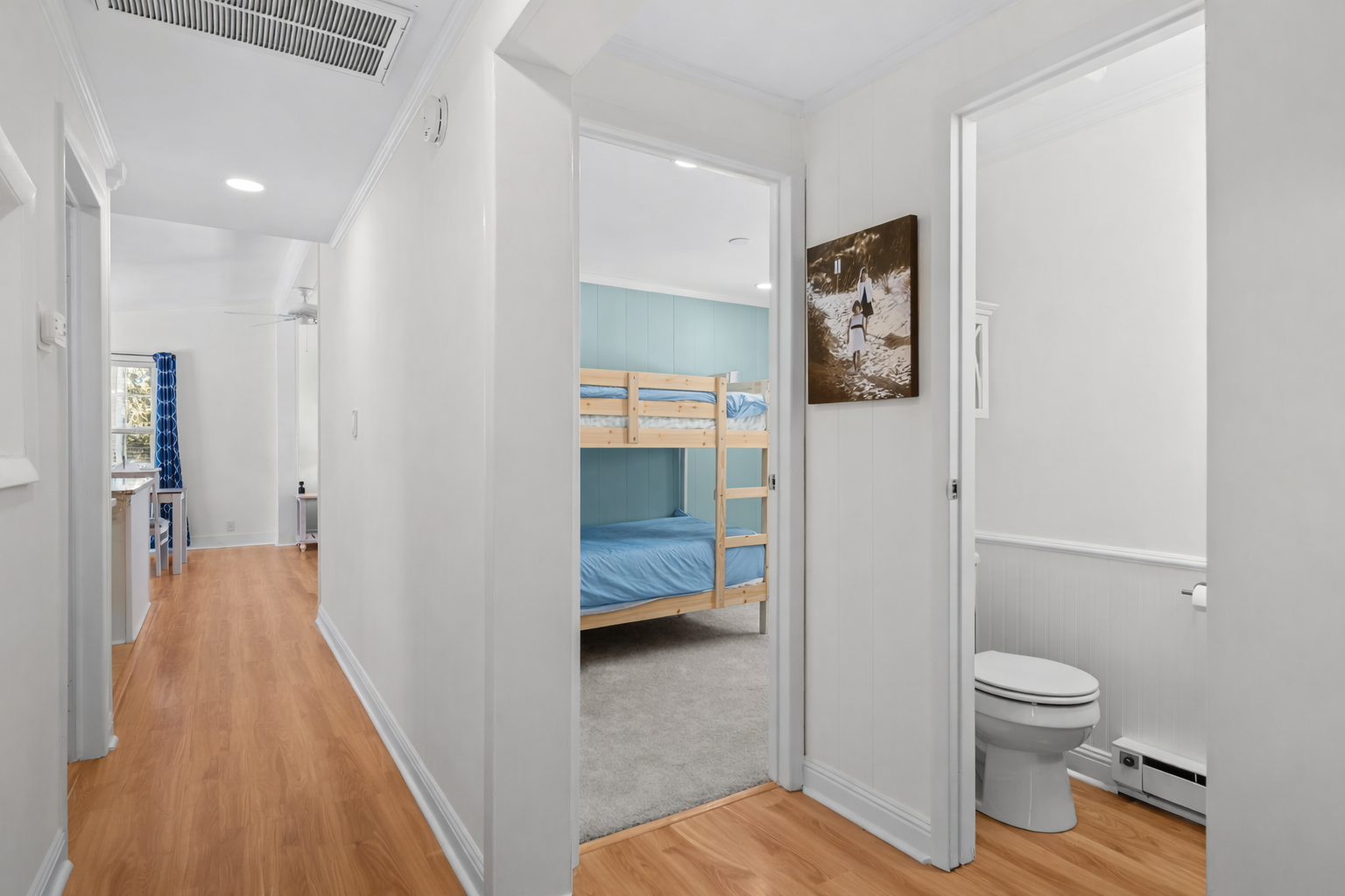Your kids will love the cozy bunk bed nook, while you'll appreciate the convenient half bath just steps away in this bright hallway.