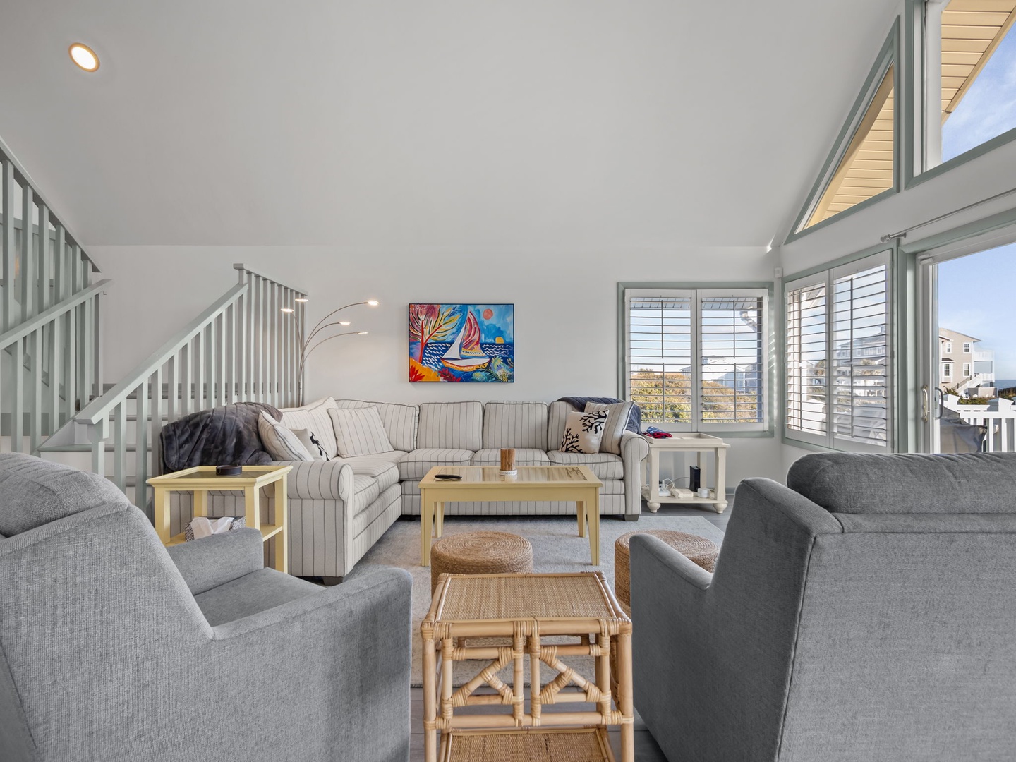 Relax in your bright, airy living space with plush seating and vibrant coastal artwork setting the perfect vacation mood.