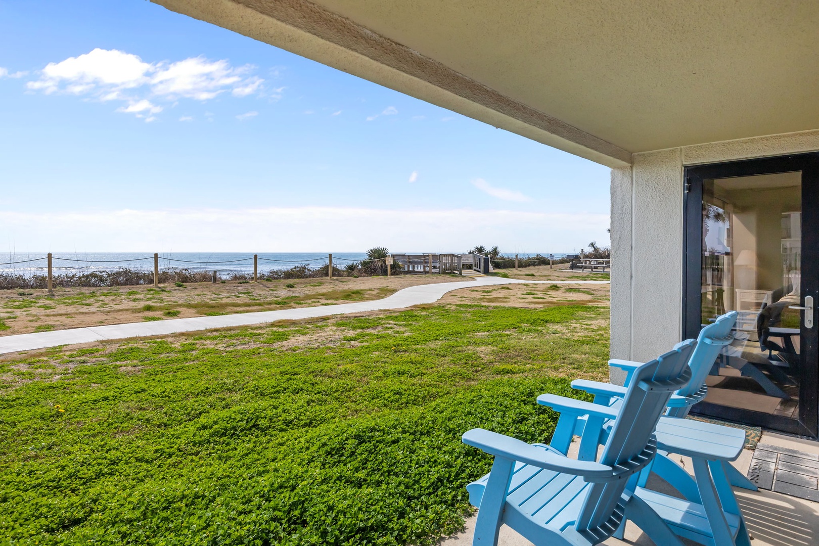 Covered patio with ocean views and comfortable seating for enjoying coastal breezes and scenic relaxation.