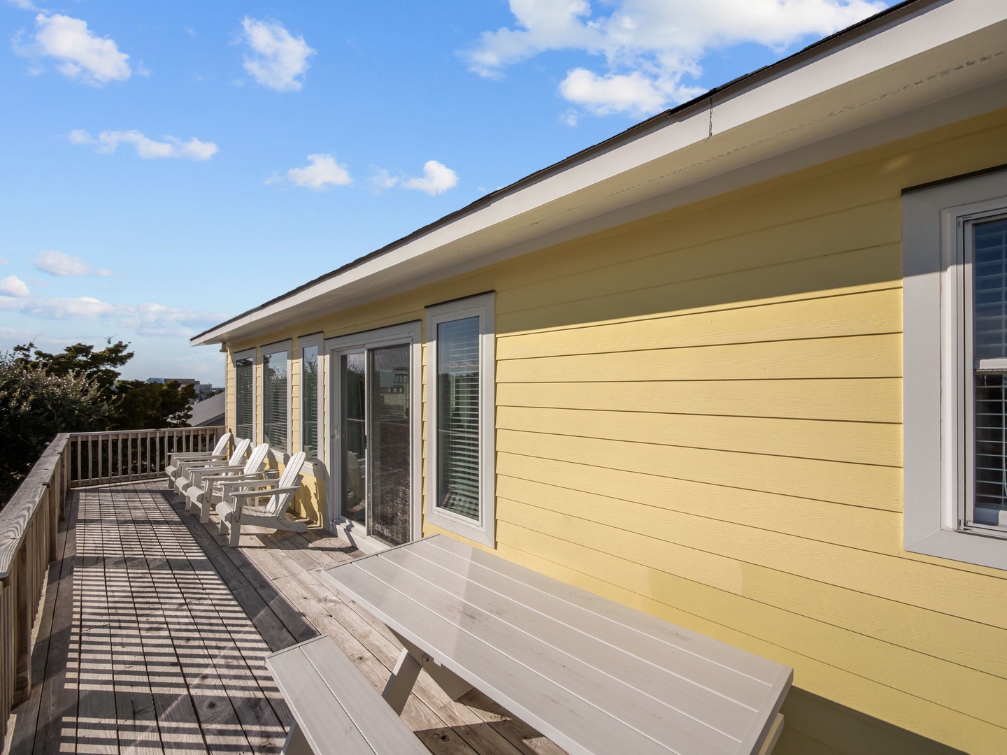 Your expansive deck beckons with weathered wood benches and Adirondack chairs, perfect for morning coffee or sunset wine while soaking in panoramic views.