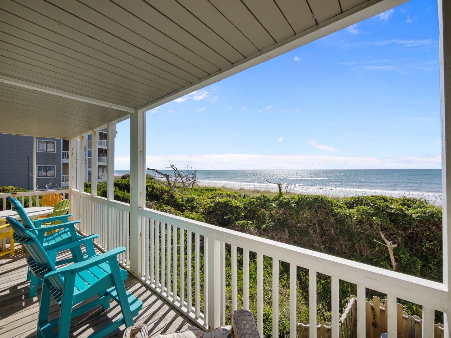 Relax in colorful beach chairs on your private covered deck overlooking pristine shoreline and endless ocean views.