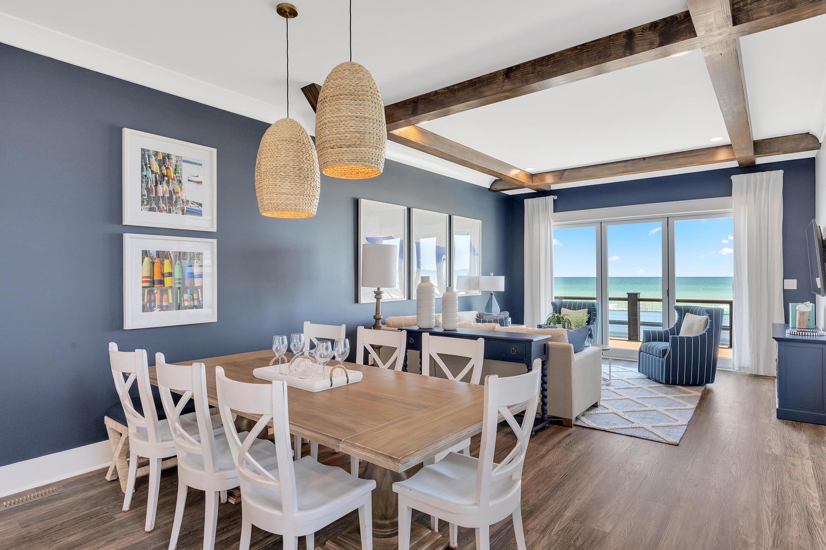 Gather around this coastal dining table with stunning ocean views just steps away. Natural light fills the space, while the open-concept layout invites you to relax and savor every moment.