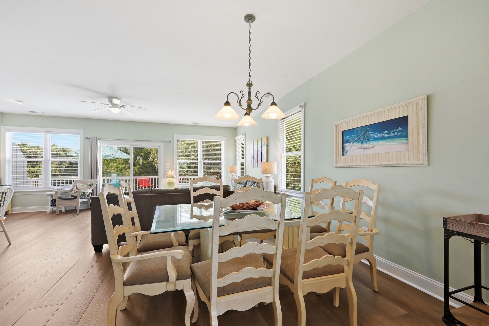 Gather around your coastal-inspired dining space, where soft sea colors meet abundant natural light. Large windows frame peaceful neighborhood views while you enjoy meals together.