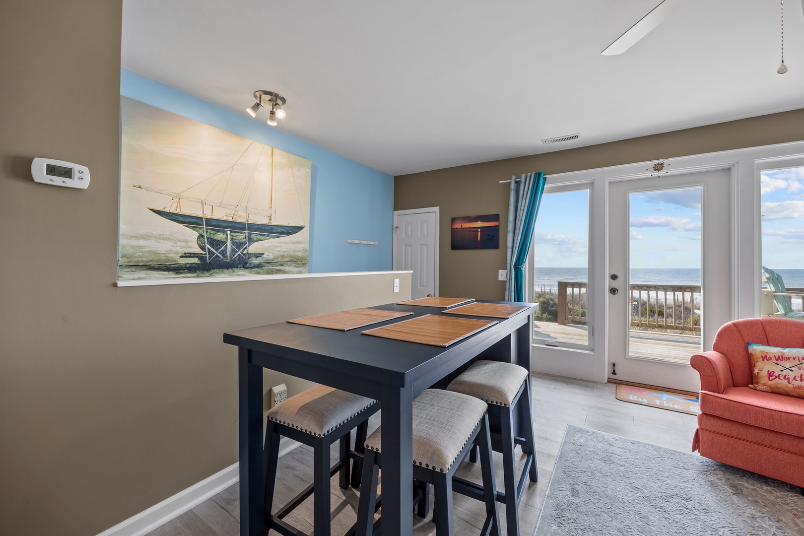 Enjoy ocean views from your dining area where coastal artwork sets the perfect beachside mood for meals.
