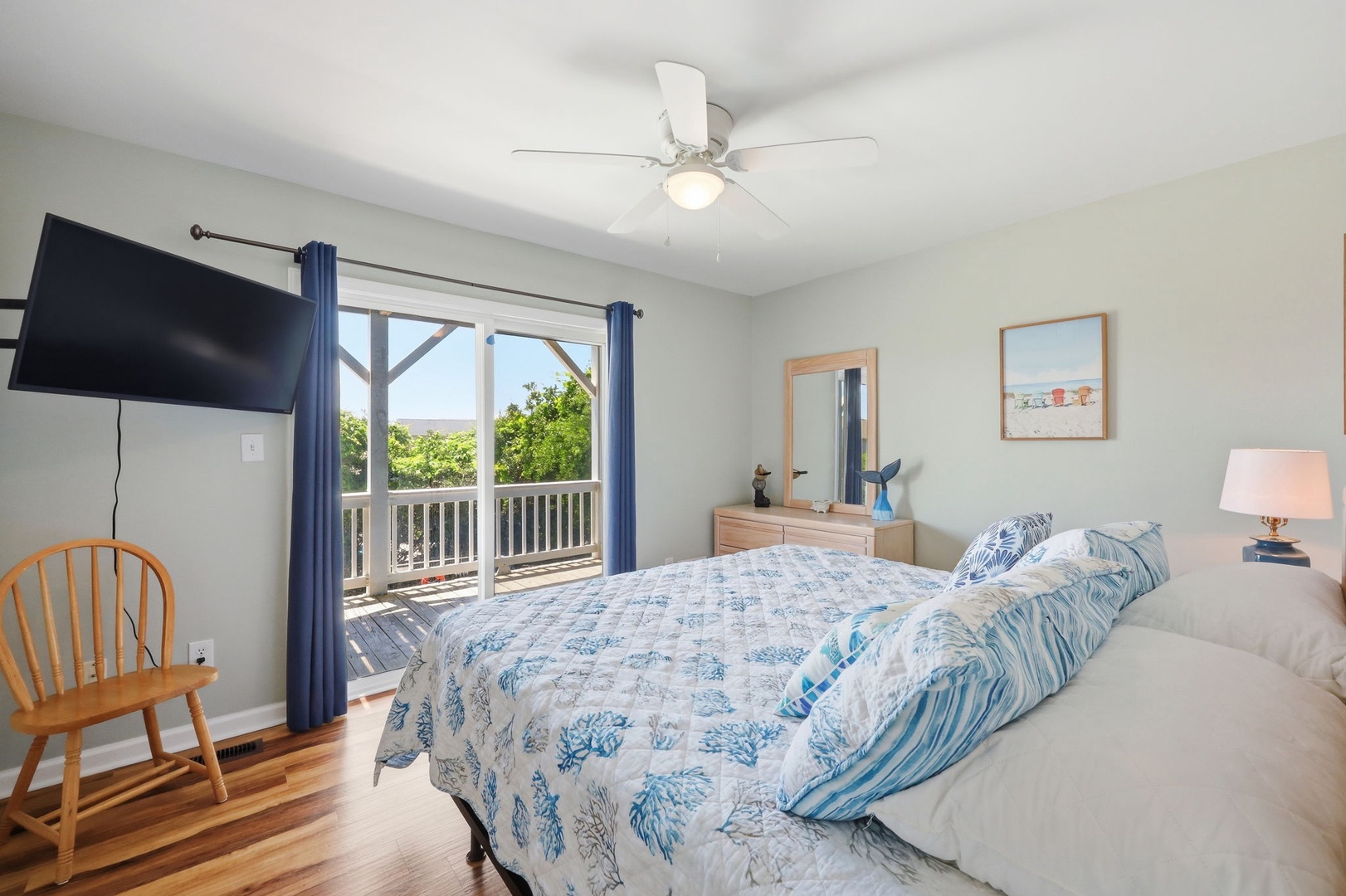 Unwind in your coastal-inspired bedroom where soft blue linens and ocean breezes through the balcony create your perfect retreat.