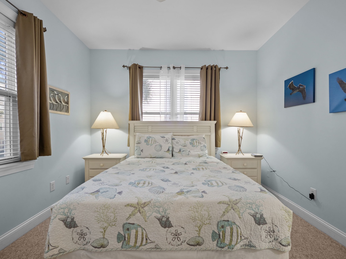 Drift off in this coastal-themed bedroom where ocean-inspired bedding and soft blue walls create your peaceful seaside retreat.