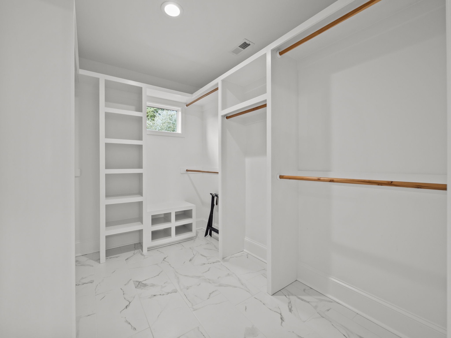 Your spacious walk-in closet features custom built-in shelving and hanging rods, giving you plenty of organized storage for all your belongings.