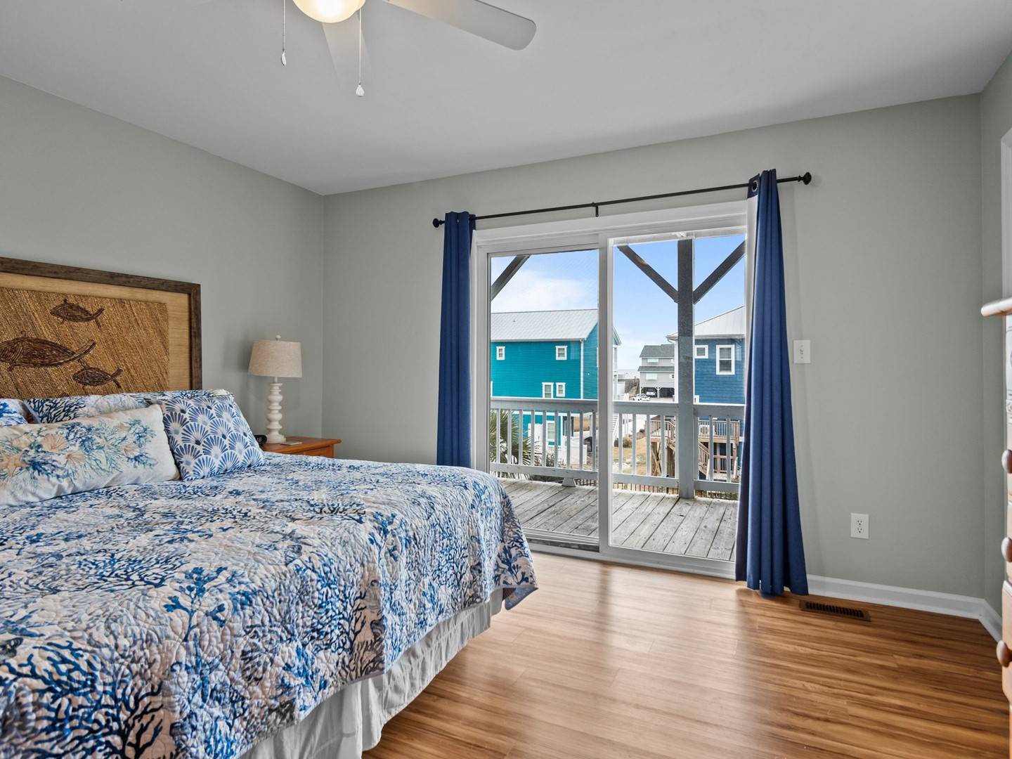 Wake up to ocean breezes in your coastal bedroom, where blue-toned linens complement the nautical charm and sliding doors open to your private deck.