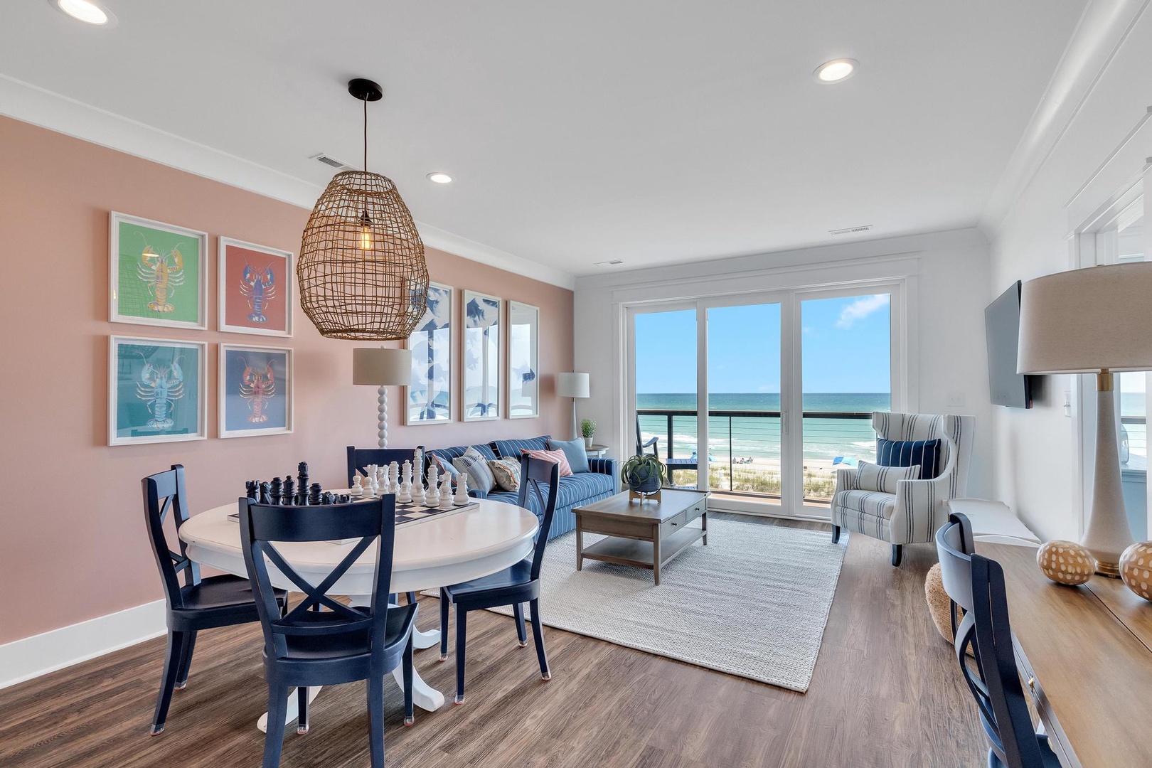 Picture yourself enjoying morning coffee with stunning ocean views through floor-to-ceiling windows, relaxing in the coastal-chic living space where beach meets comfort.