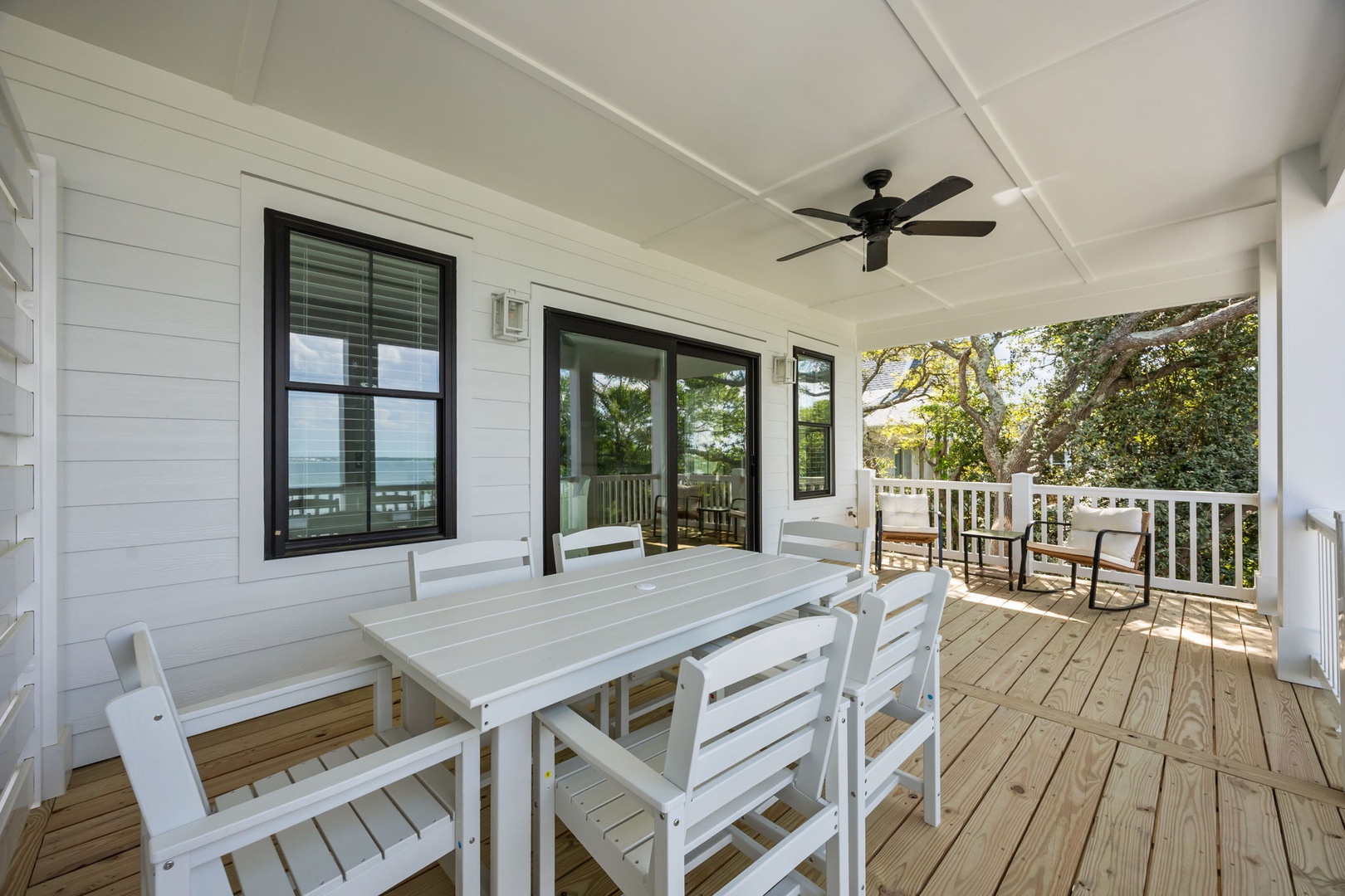 Your spacious covered deck offers the perfect spot for outdoor dining with comfortable seating and gentle breezes from the ceiling fan.