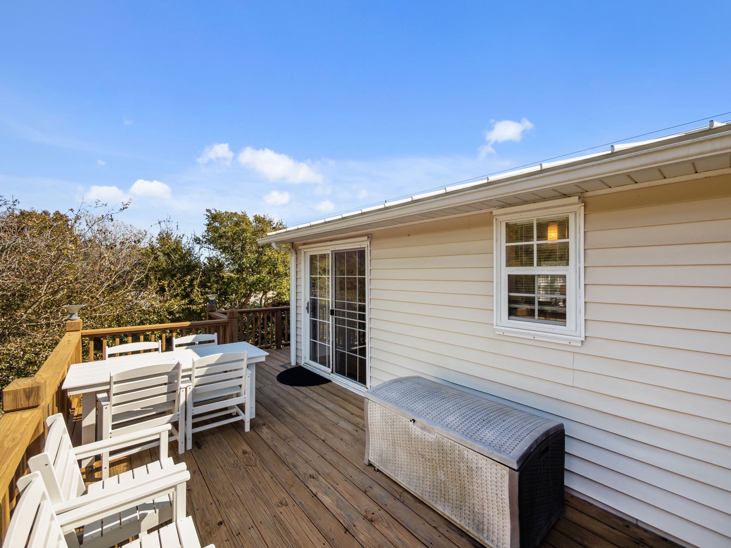 Step onto your private deck with outdoor seating and storage, perfect for morning coffee under the blue sky.
