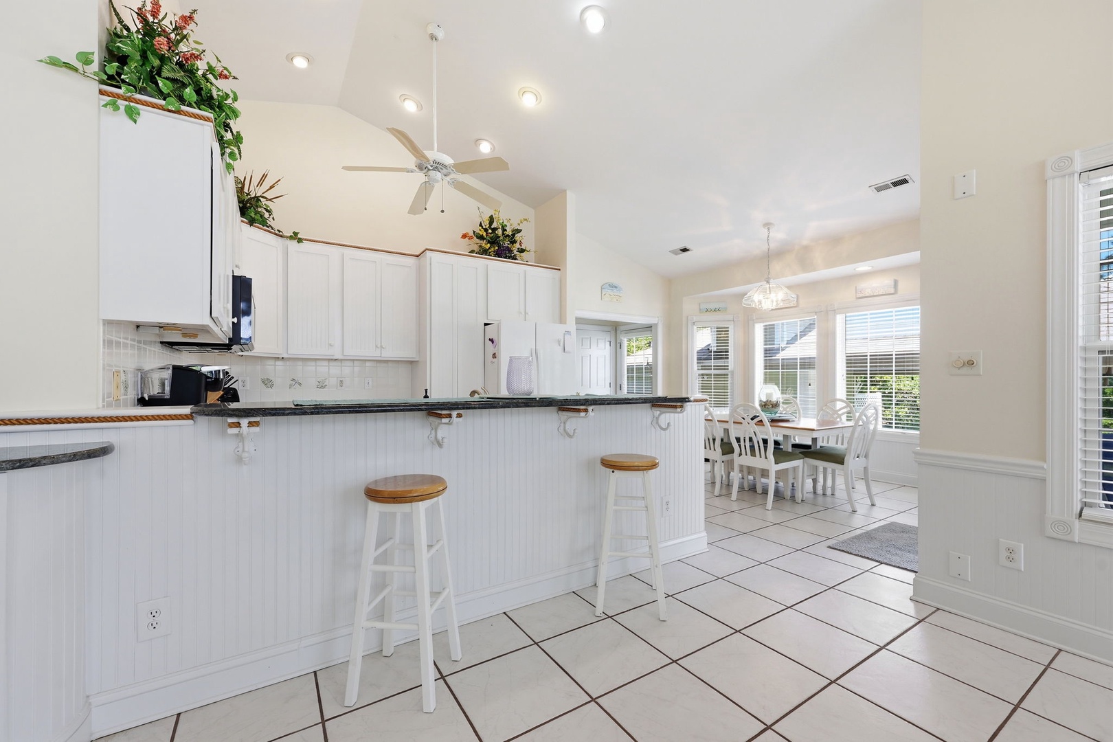 Bright, open kitchen with breakfast bar seating flows into your dining space—perfect for morning coffee or casual meals with loved ones.