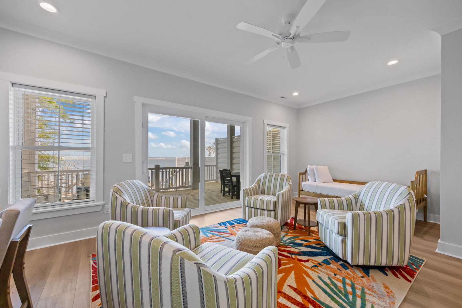 Relax in your bright living space with stylish striped chairs and colorful decor, while enjoying direct access to your private outdoor deck.