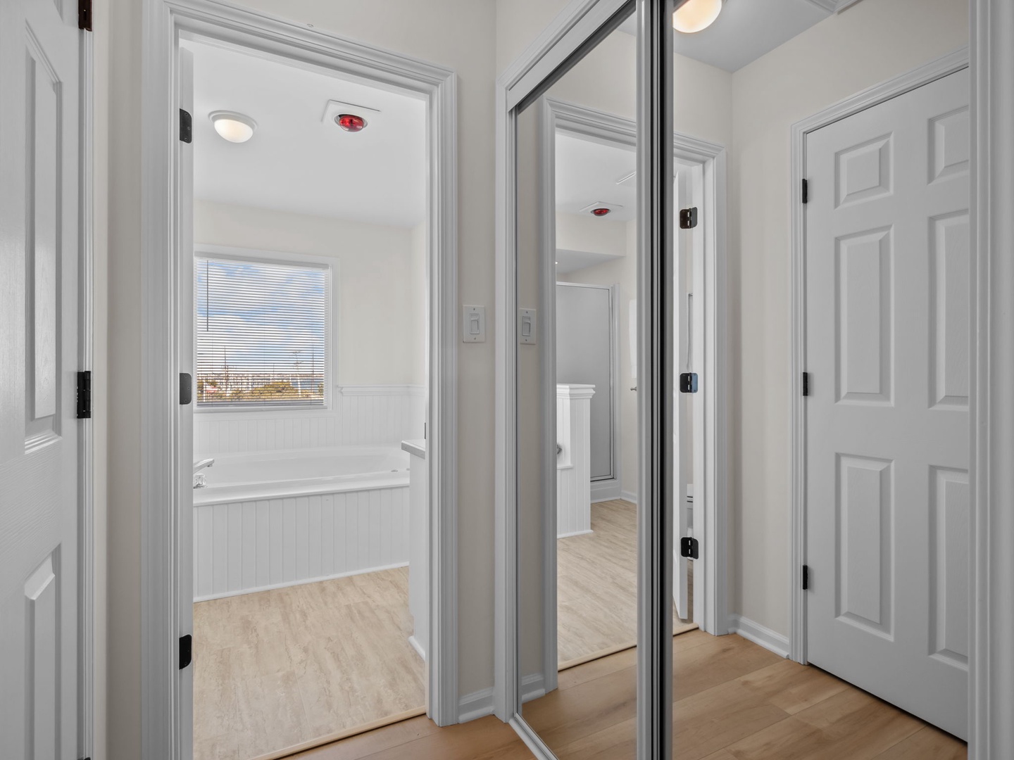 Your spacious bedroom suite features a luxurious soaking tub positioned perfectly beside the window, where you can unwind while taking in scenic views.