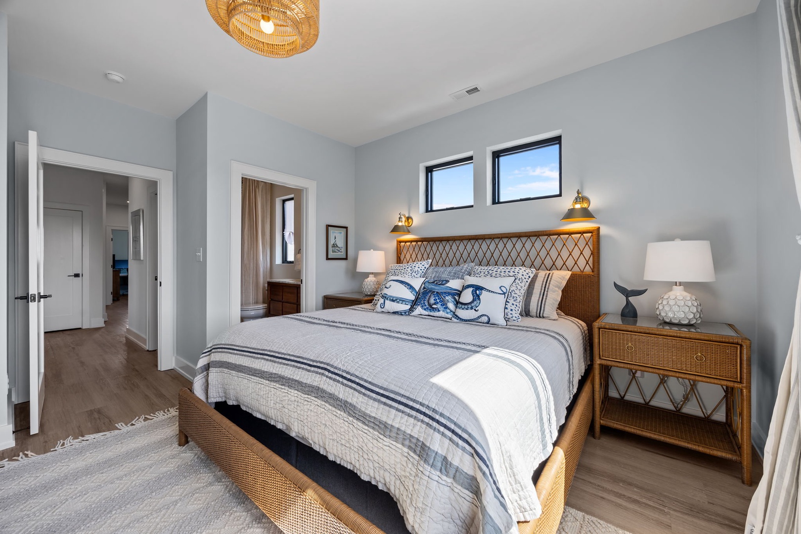 Drift into peaceful sleep in your coastal-inspired bedroom, featuring beautiful natural textures and ocean-themed linens that create a serene retreat.