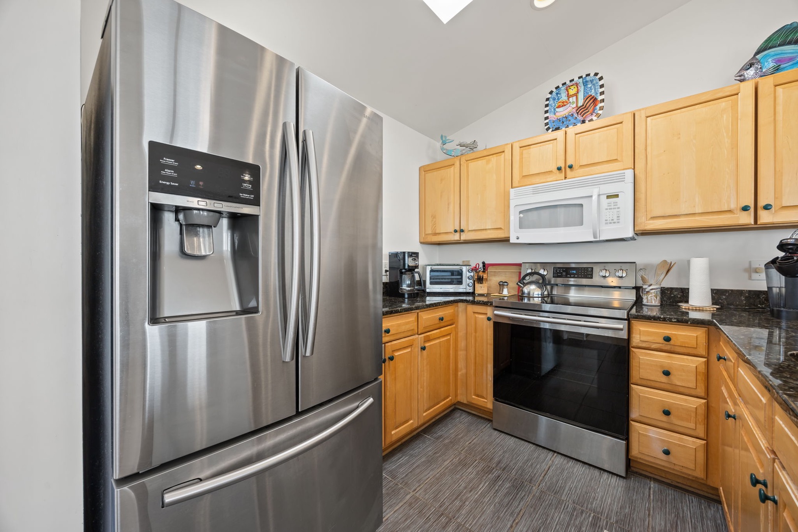Your fully equipped kitchen features stainless steel appliances and warm wood cabinetry, perfect for preparing memorable meals during your stay.