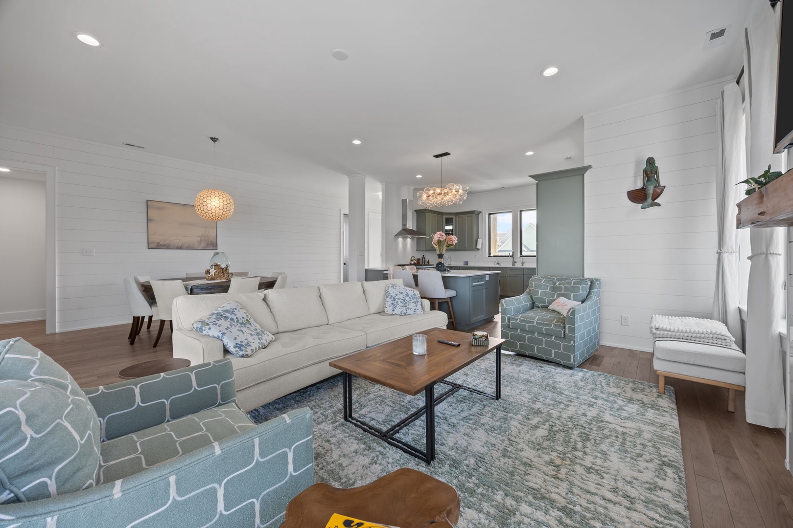 Unwind in your stylish living space featuring coastal-inspired décor, soft textures, and an open layout connecting to your gourmet kitchen.