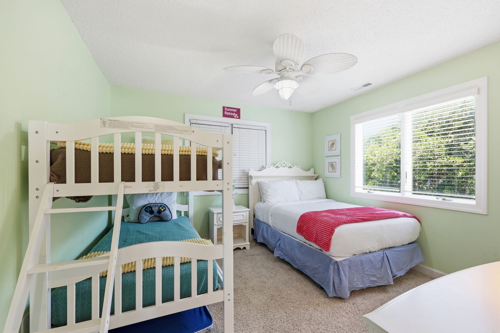 Step into a cheerful bedroom designed with both comfort and fun in mind. Soft mint-green walls create a calming atmosphere, while the bunk bed and queen bed offer flexible sleeping arrangements for your family or group.