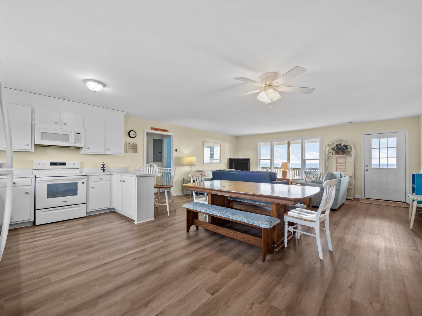 Gather around your spacious dining table while bathed in natural light from large windows.