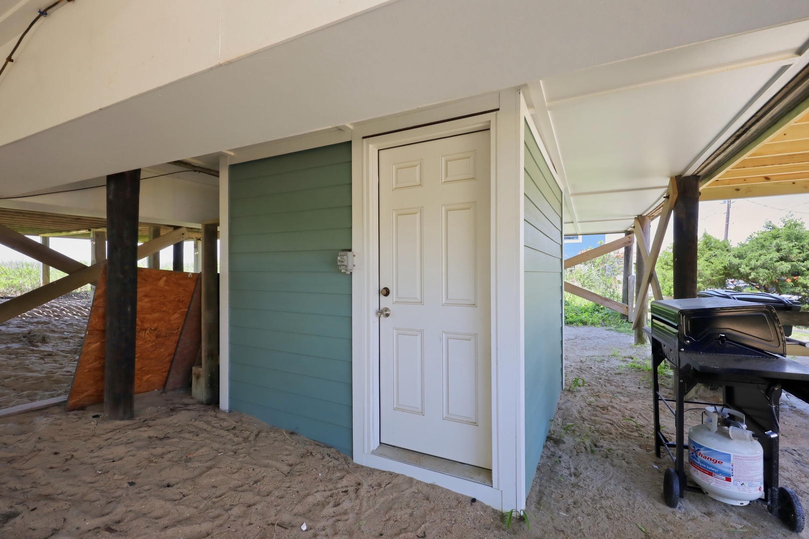 A covered beachfront patio with direct access to the sand, BBQ grill ready for your seaside cookouts, and storage for your beach gear.