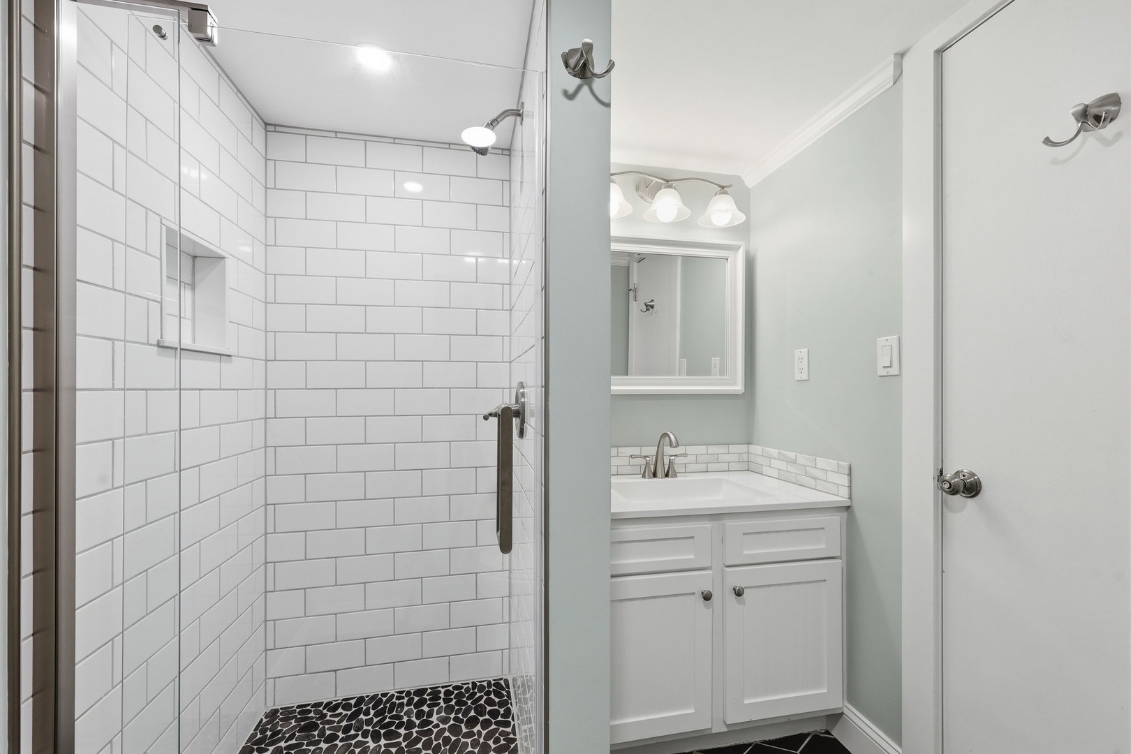 Refresh after your adventures in this pristine bathroom, featuring a spacious subway-tiled shower and modern vanity with all the essentials for your comfort.