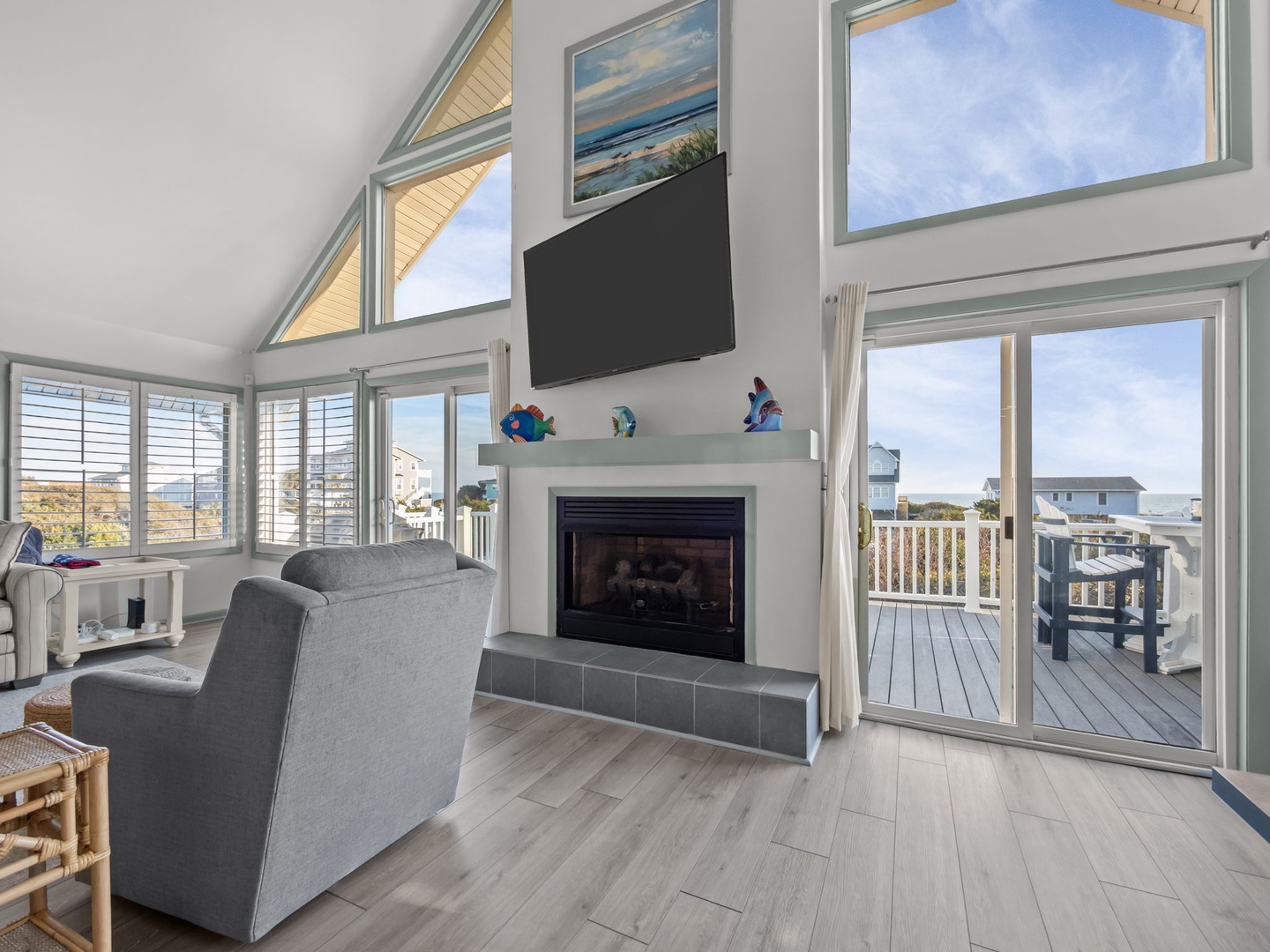 Relax in your bright living room with soaring ceilings, cozy fireplace, and sweeping views through floor-to-ceiling windows.