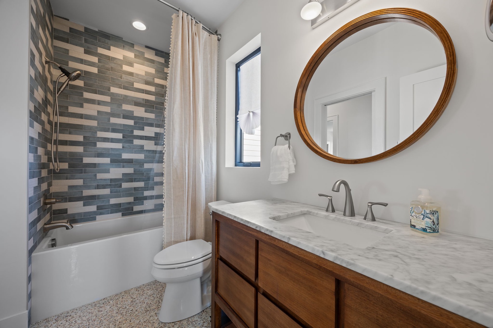 Unwind in your stylishly appointed bathroom featuring elegant marble countertops, soothing tile accents, and a relaxing tub for rejuvenating soaks.