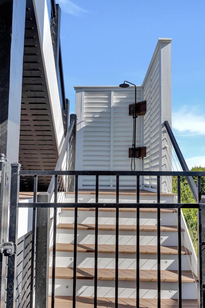Private outdoor shower with natural light and modern privacy screens, perfect for rinsing off after the beach or pool.