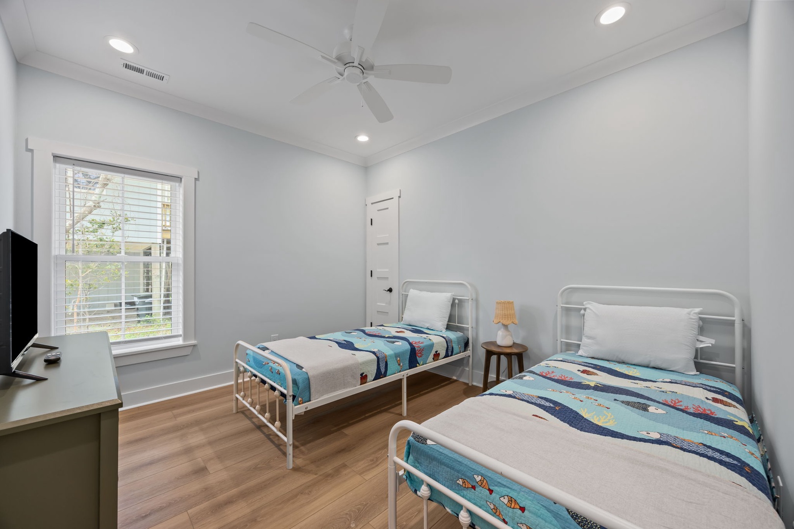 Your bright twin bedroom offers comfortable single beds with cheerful linens, perfect for kids or friends traveling together.
