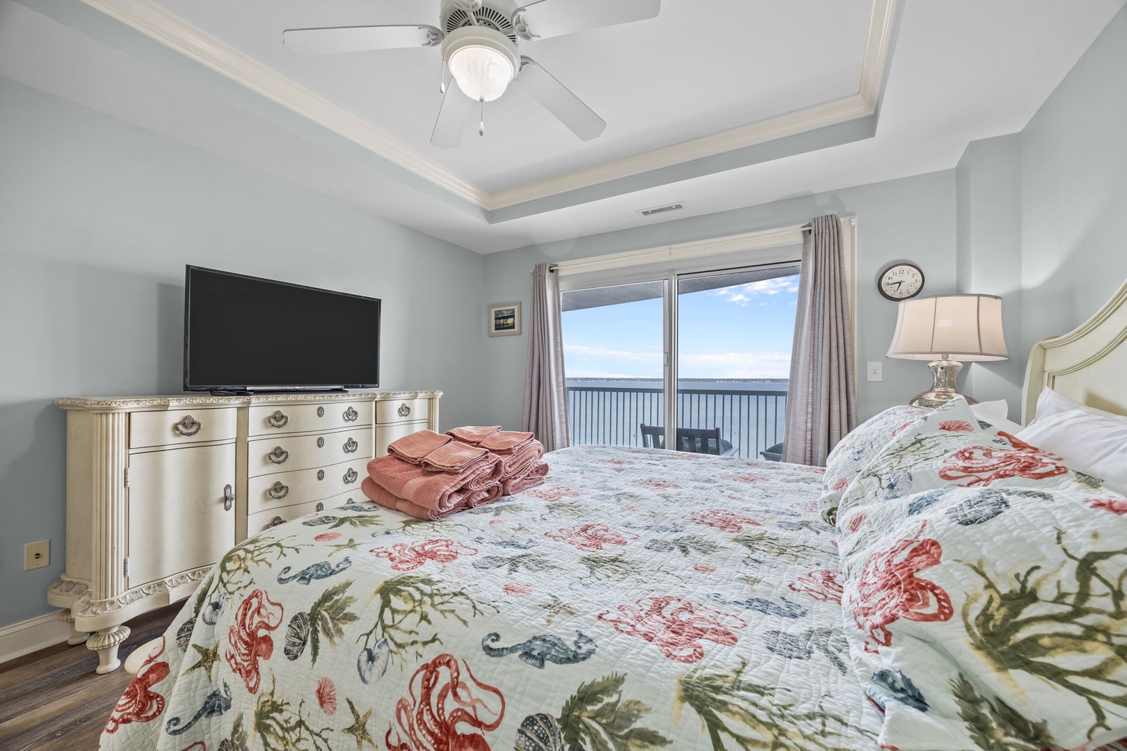 Wake to ocean views from your bed and enjoy peaceful mornings with gentle ceiling fan breezes and soft natural light.