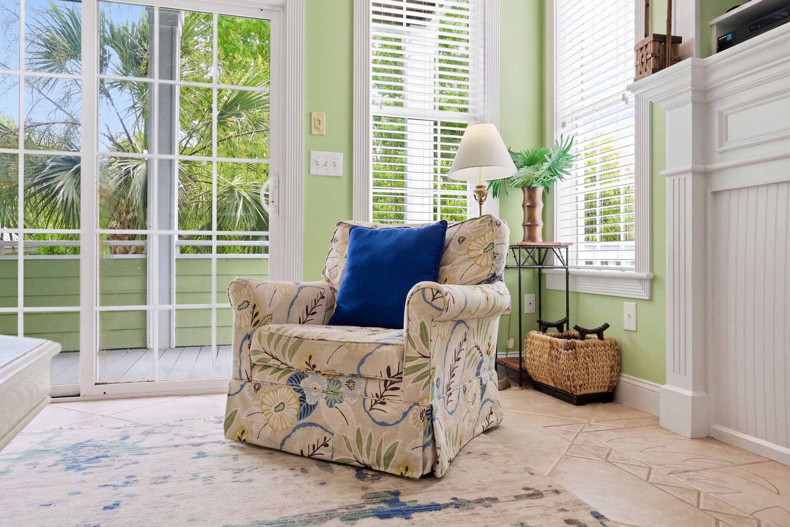 Curl up in your cozy reading nook with natural light pouring in through French doors, overlooking tropical palms and gentle breezes—a perfect spot to unwind.