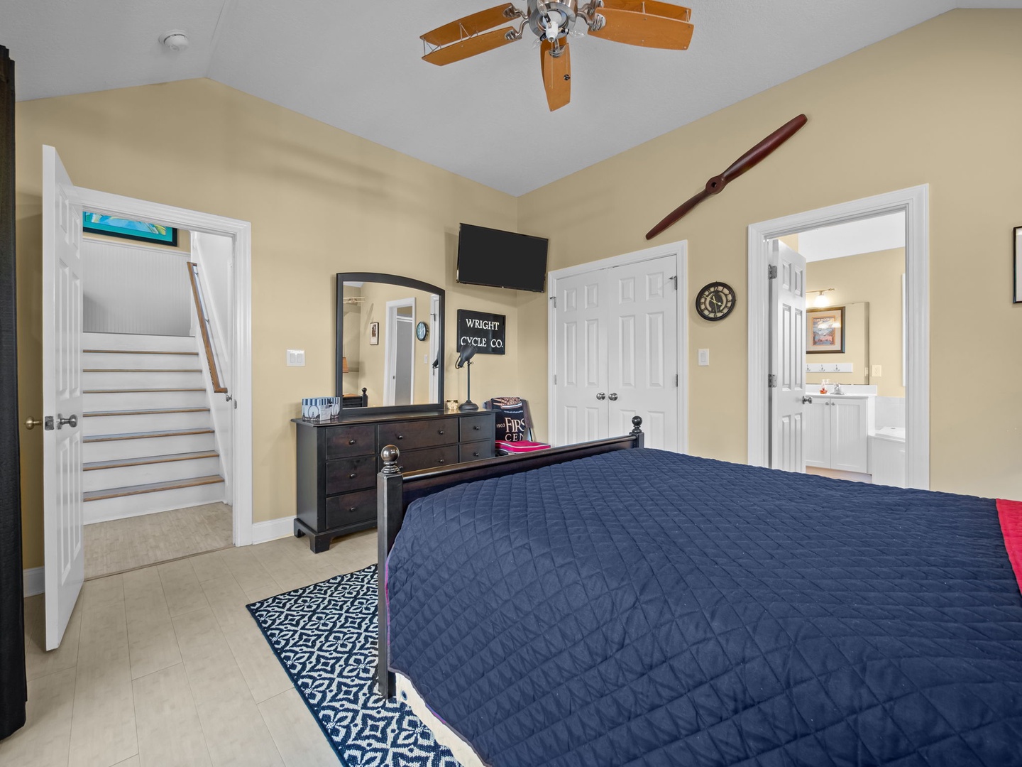 Your bright bedroom features a ceiling fan, TV, and private bathroom for ultimate comfort during your stay.