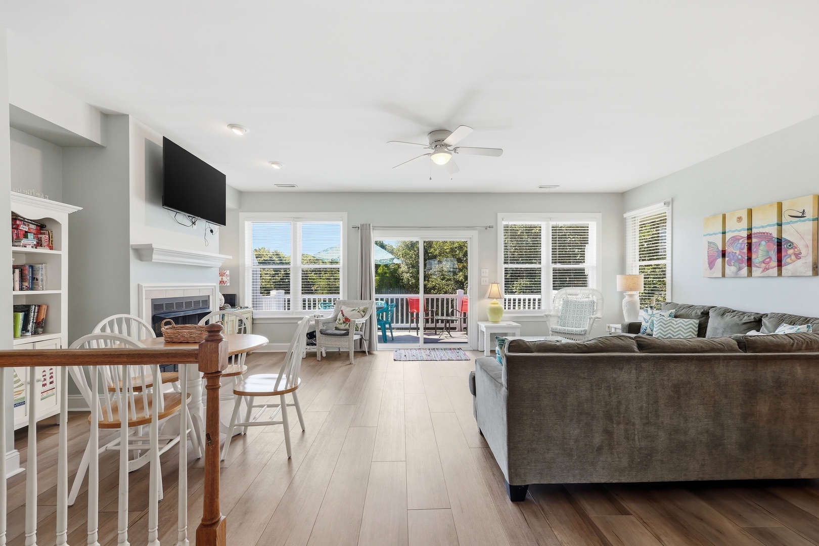 Relax in your bright, open living space with dining, comfortable seating, and a fireplace for cozy evenings. Sliding doors reveal a balcony with lounge chairs awaiting your morning coffee.