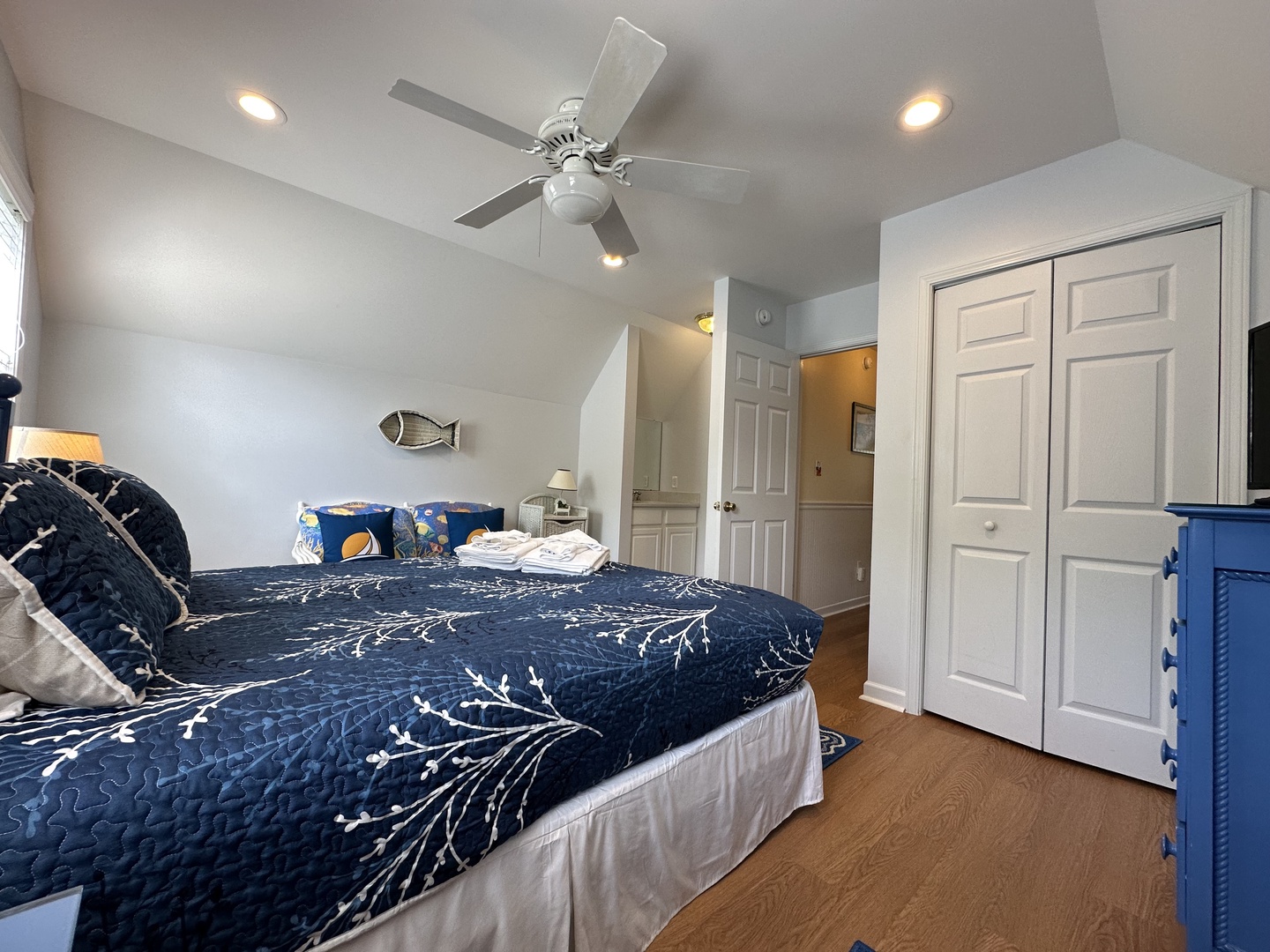 Unwind in your cozy bedroom with nautical touches, a ceiling fan, and ample closet space—your seaside retreat awaits.