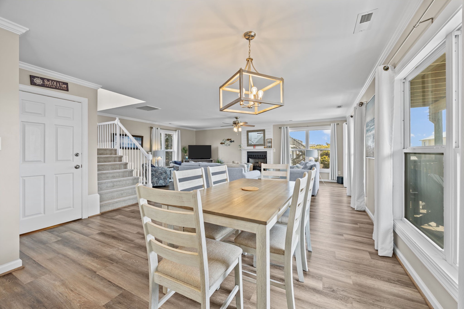 Gather around your spacious dining table while natural light streams through floor-to-ceiling windows, creating the perfect setting for memorable meals together.