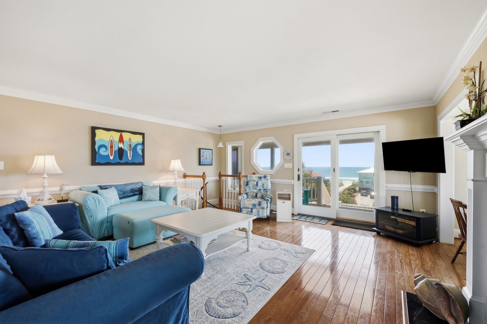 Sink into plush coastal-blue furnishings while ocean waves shimmer through picture windows. Your private beachfront living room invites barefoot relaxation and peaceful mornings with coffee.