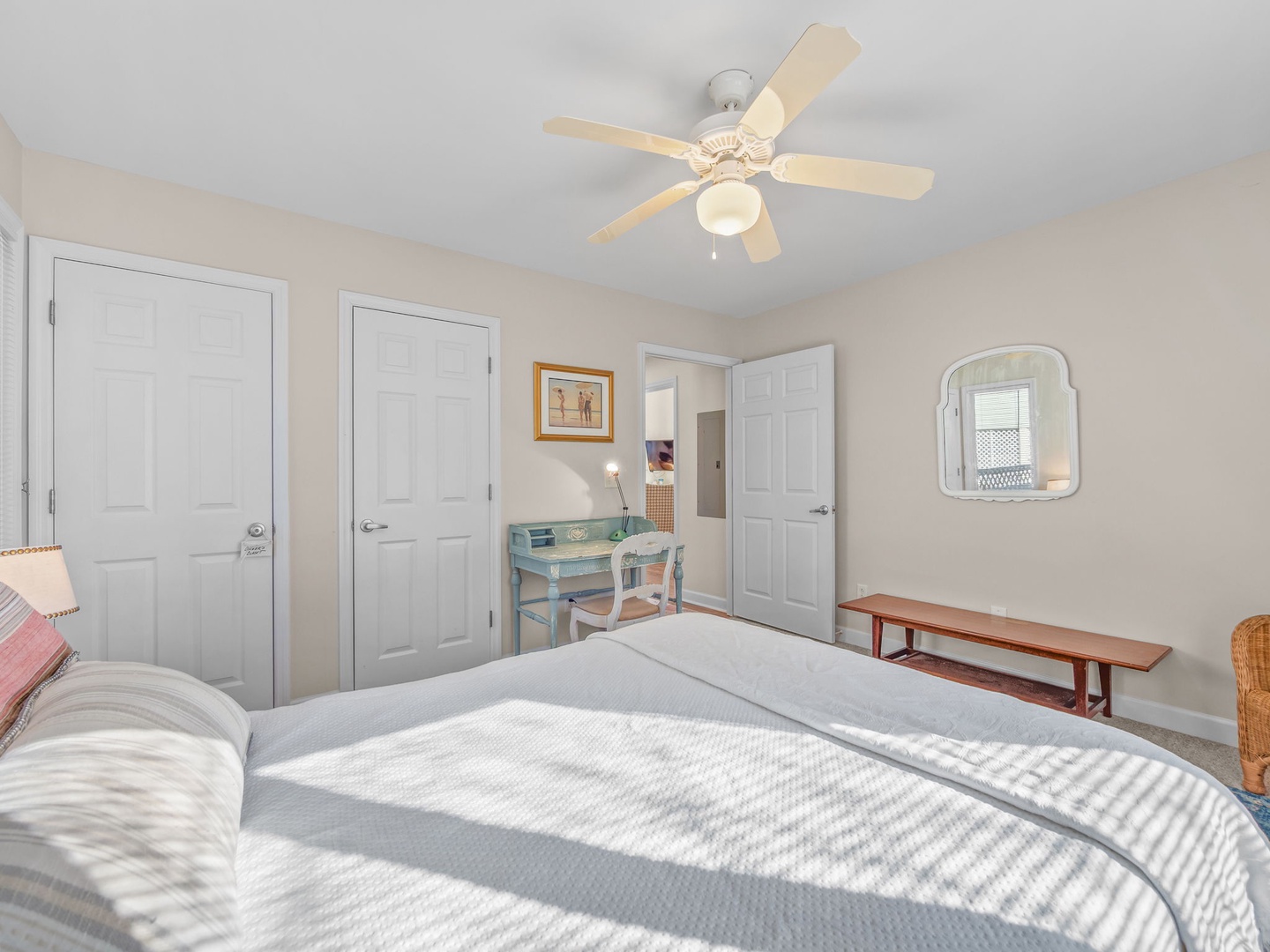 Your peaceful bedroom features a comfortable bed with soft linens, charming desk workspace, and ceiling fan to keep you cool.