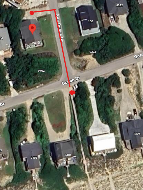 Aerial view of the neighborhood showing residential streets and surrounding properties with established landscaping.