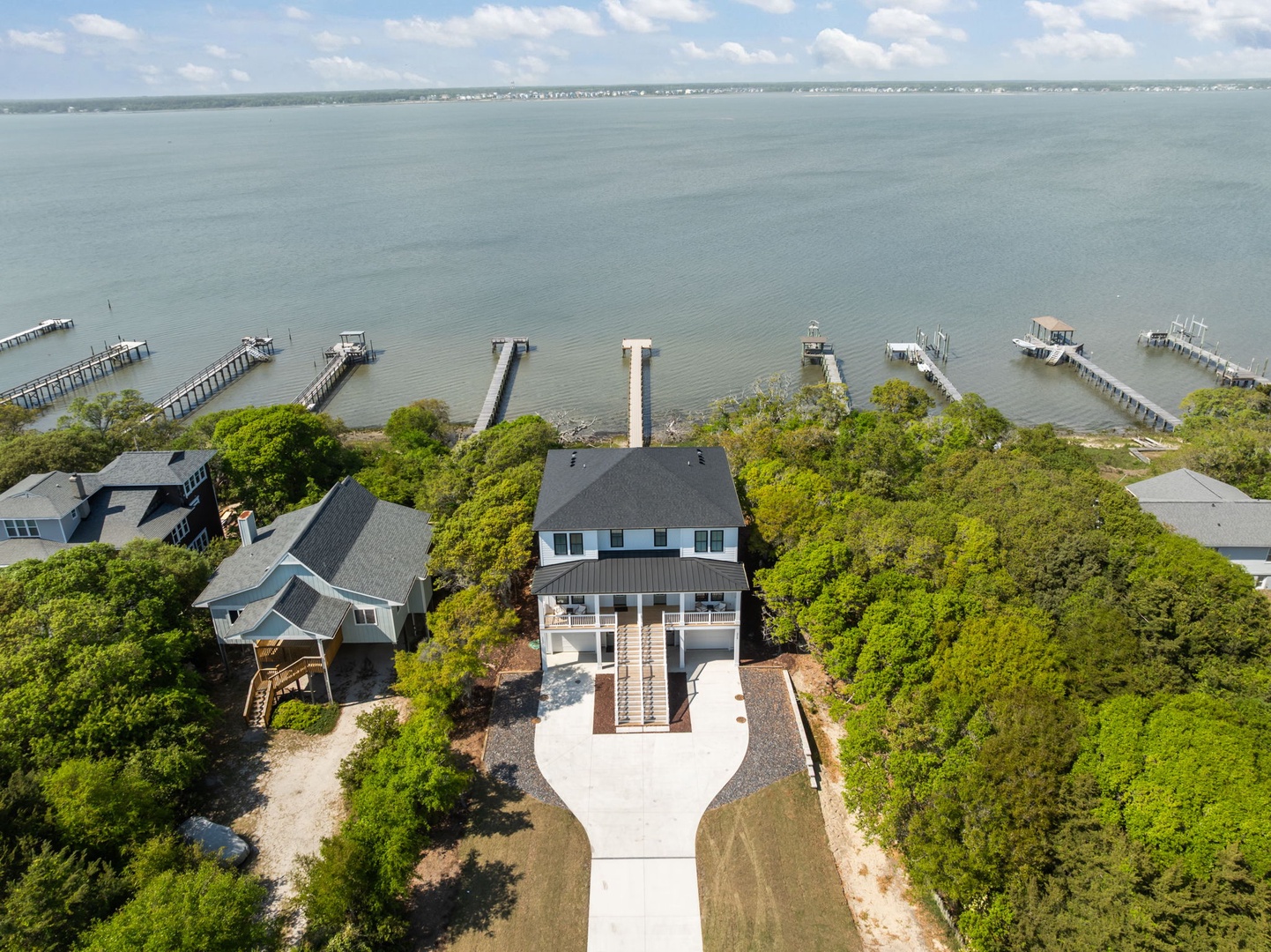 Stunning waterfront property nestled among mature trees with private dock access and panoramic bay views.