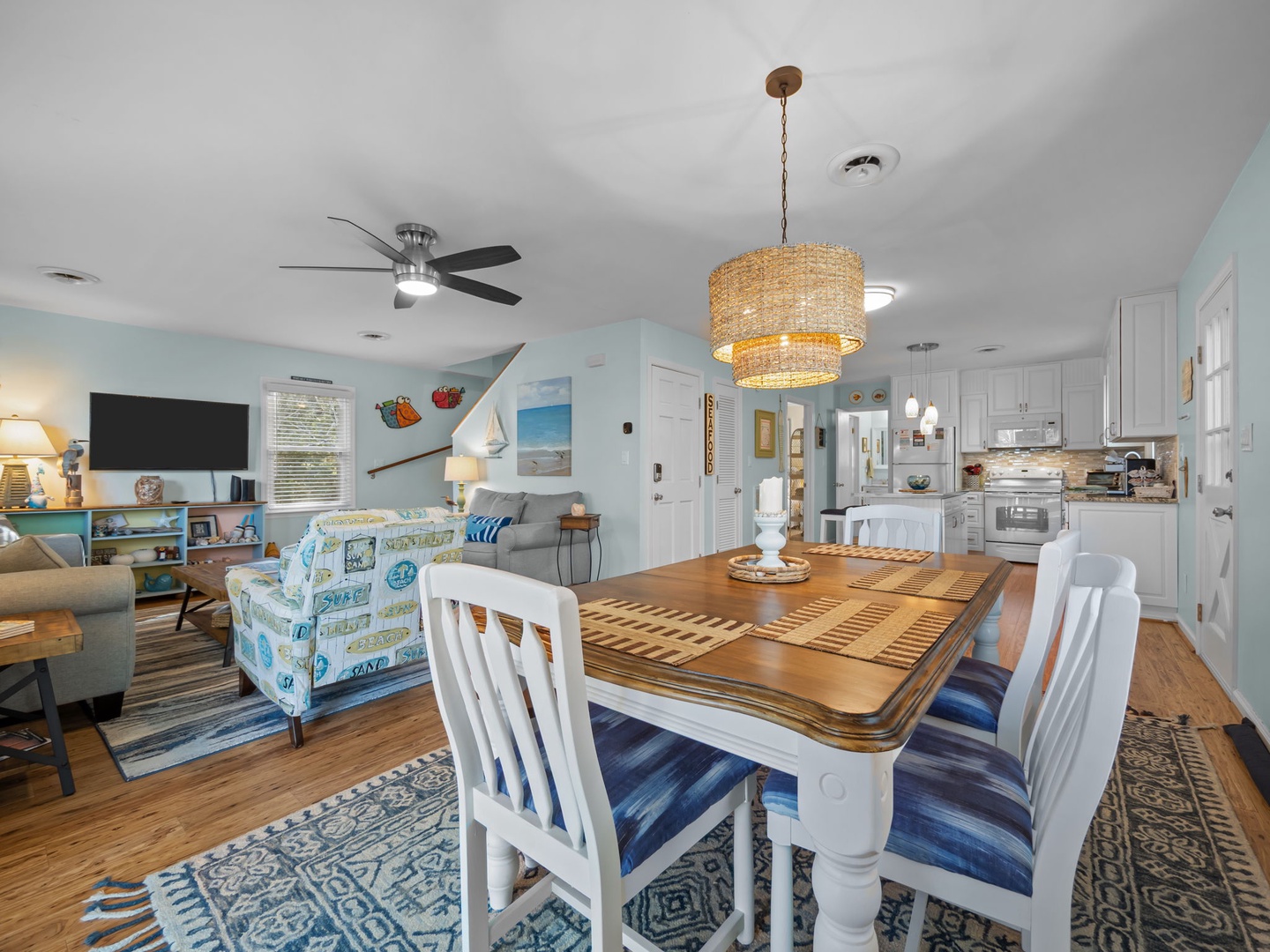 Your coastal haven flows seamlessly from dining to living, where ocean-themed decor and nautical touches create the perfect beachside retreat.