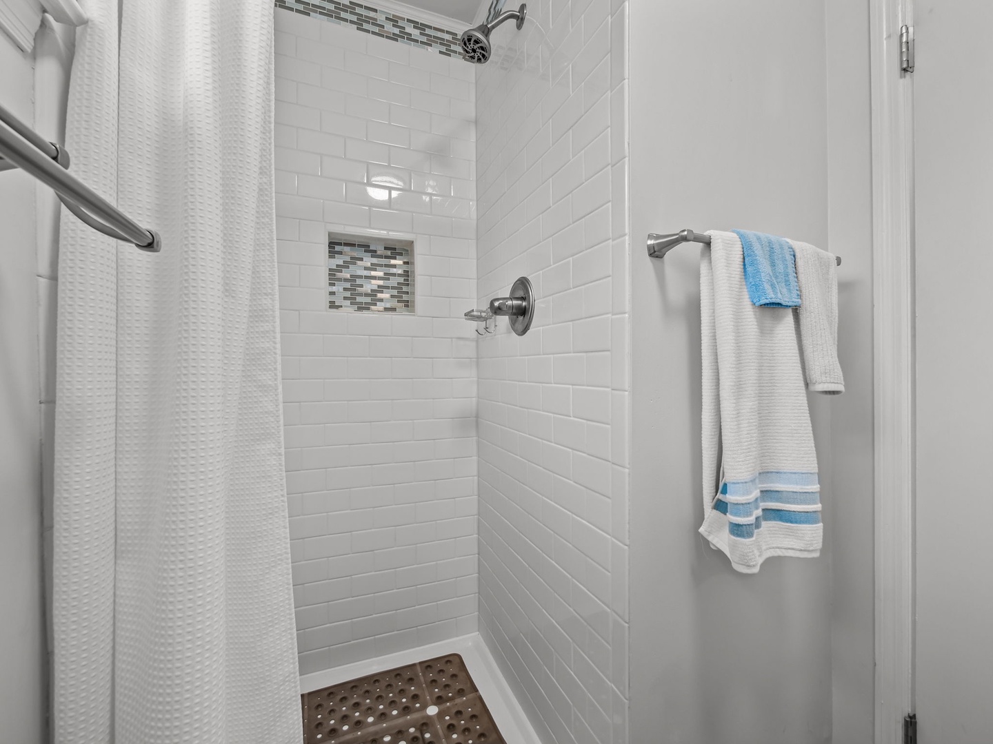Step into your refreshing shower with elegant subway tiles and modern fixtures, perfectly designed for your comfort.