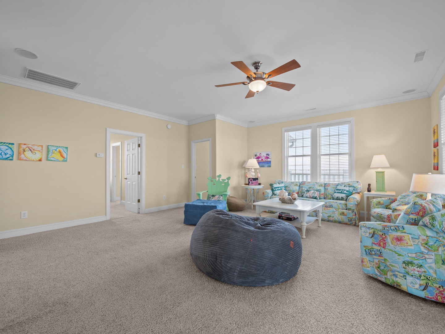 Relax in your spacious living room with tropical-themed furniture and a cozy bean bag for casual lounging.