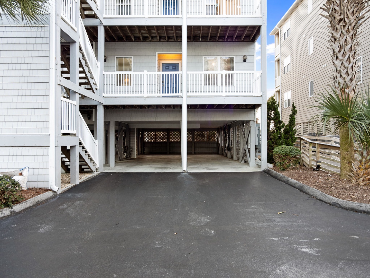 Covered parking garage with space for two vehicles beneath this coastal vacation rental property.