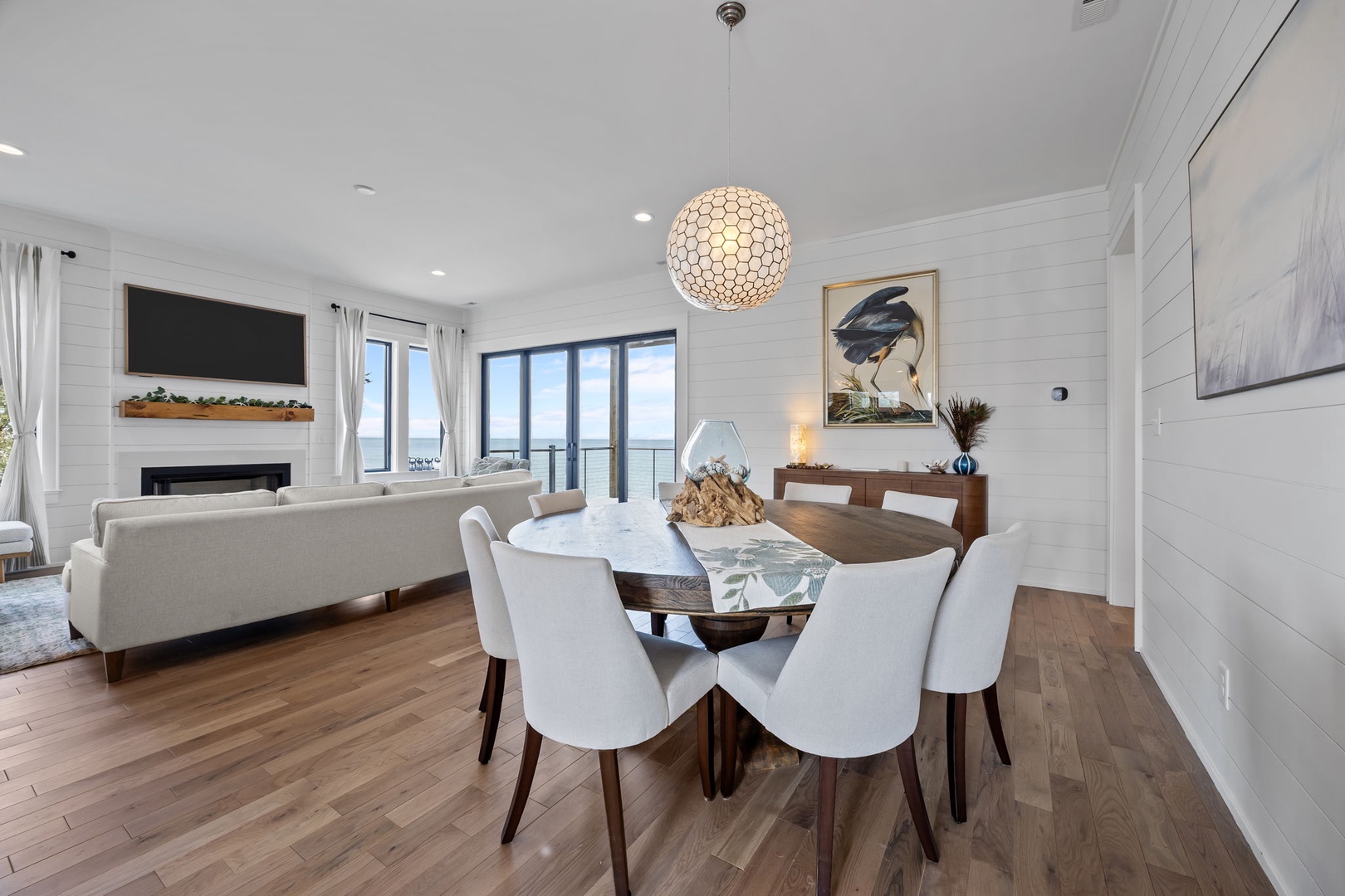 Gather around your elegant dining table for memorable meals, while natural light fills this stylish space with stunning views.