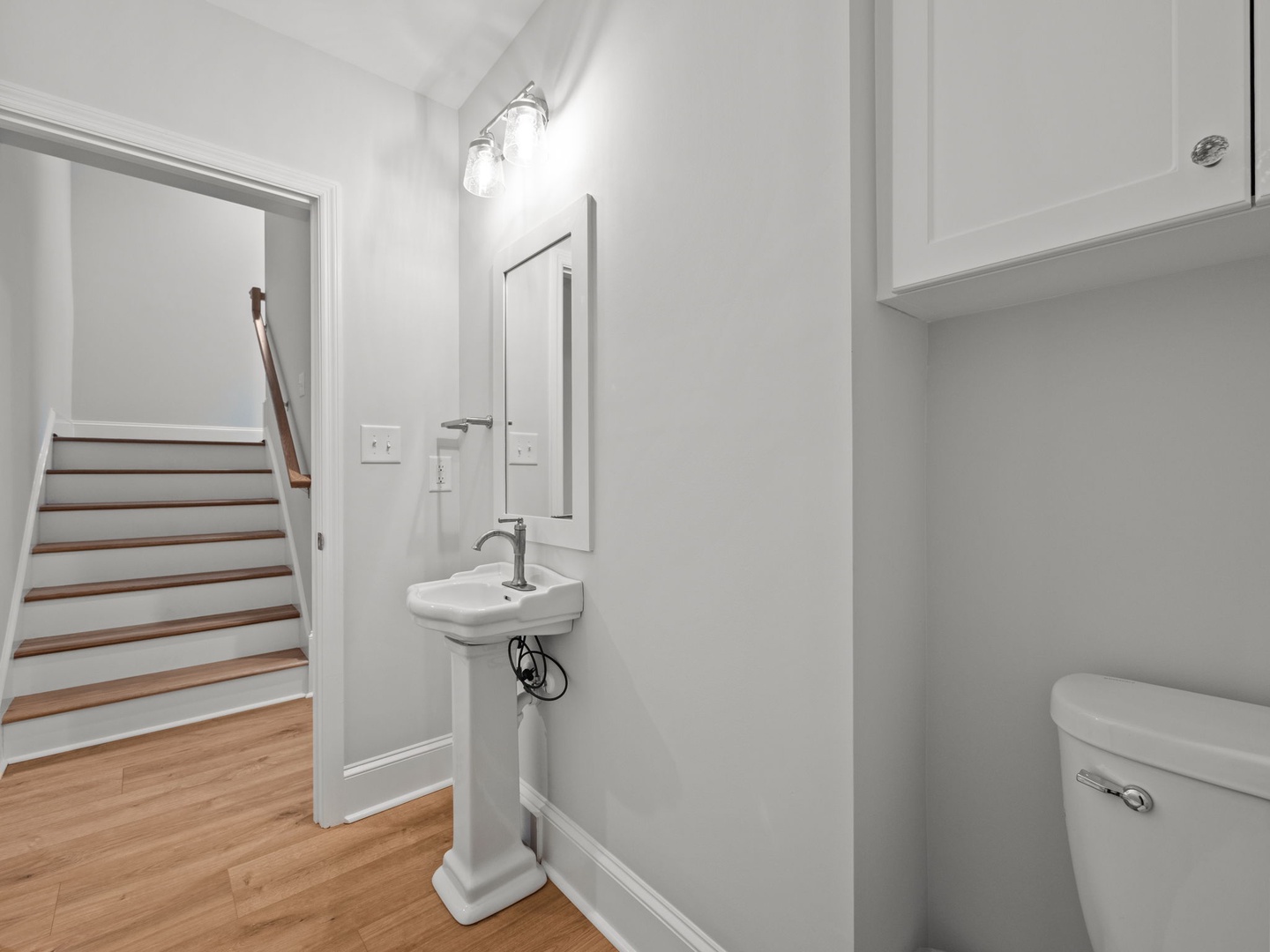 Freshen up in your stylish powder room featuring clean lines, modern fixtures, and bright lighting for your comfort.