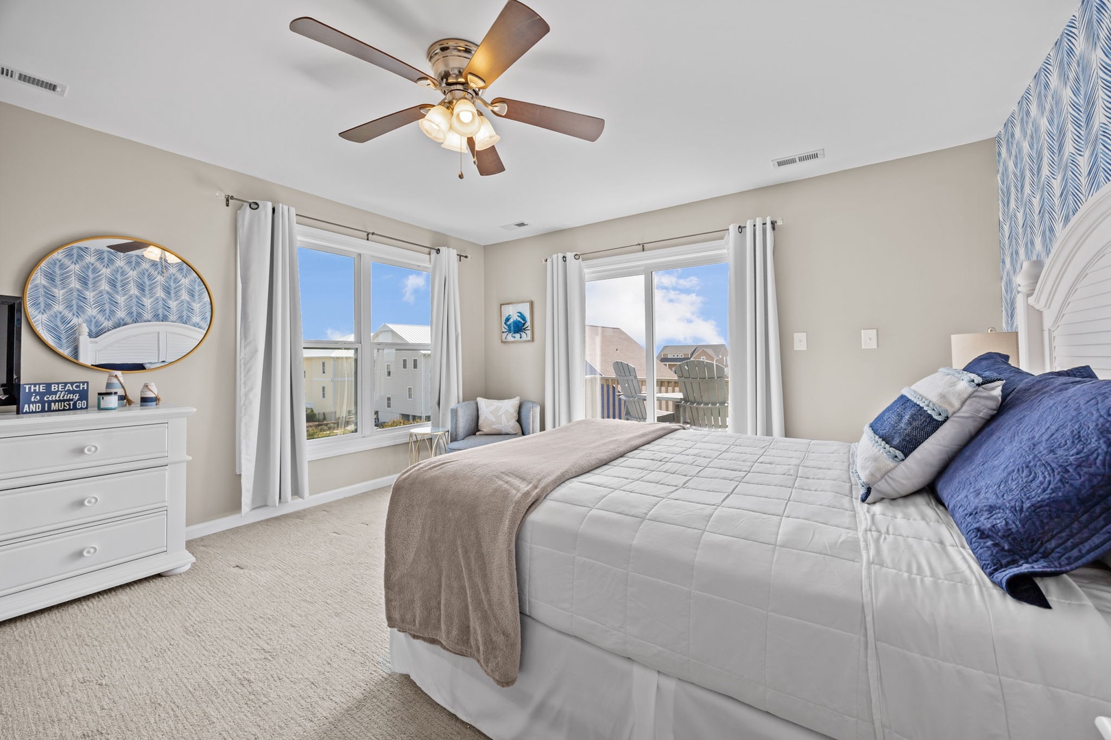 Wake up refreshed in your coastal bedroom with soft blue accents and natural light streaming through your windows.