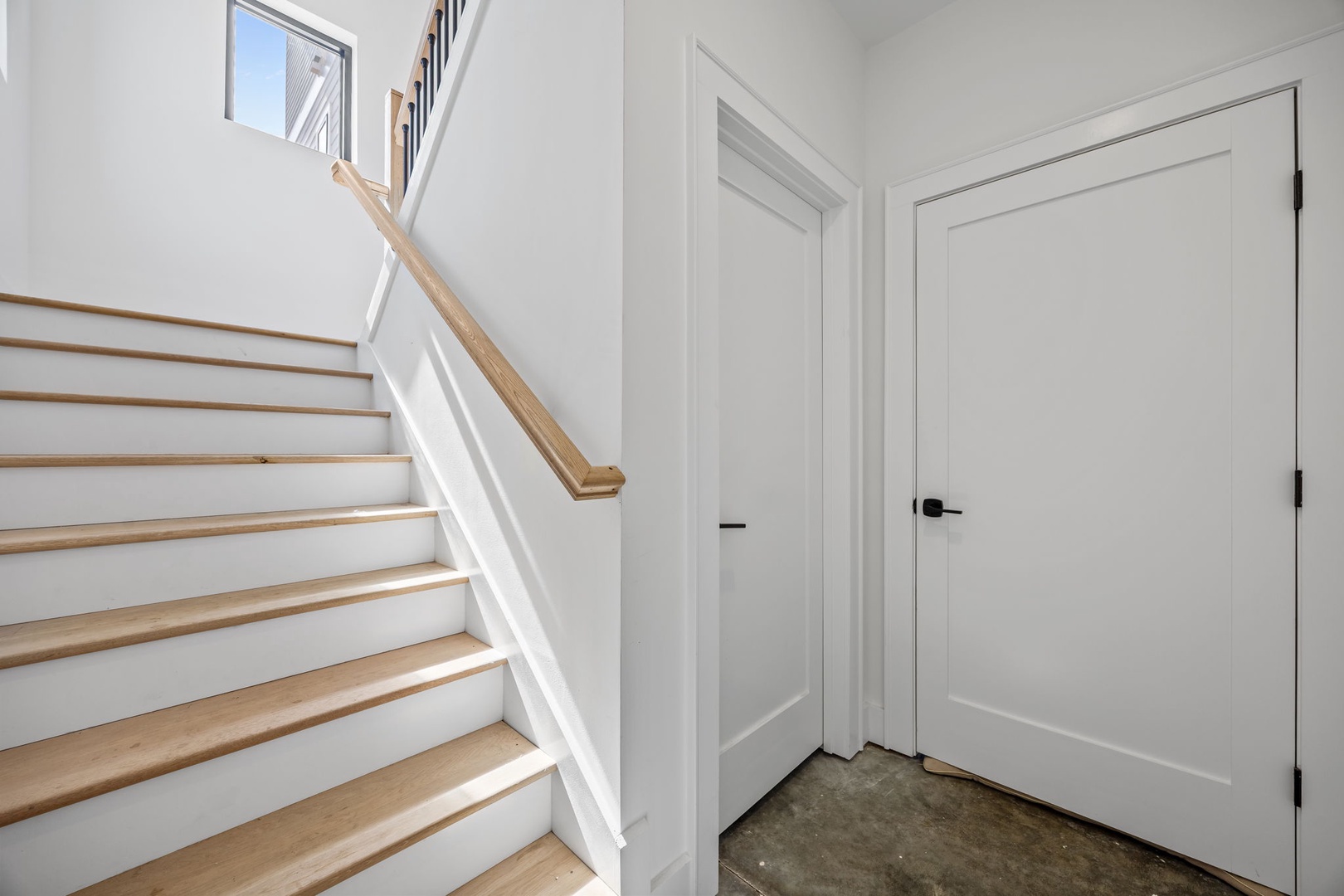Climb the bright staircase to your upstairs retreat, where natural light and clean modern design create your perfect home base.