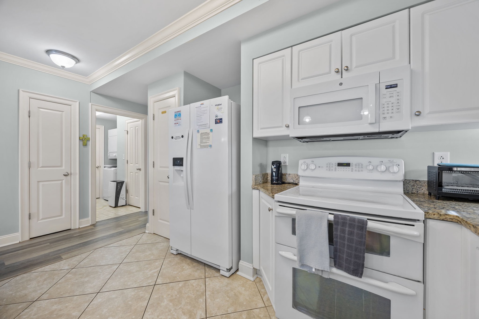 Your fully equipped kitchen awaits with granite counters, white appliances, and everything you need to create memorable meals during your stay.