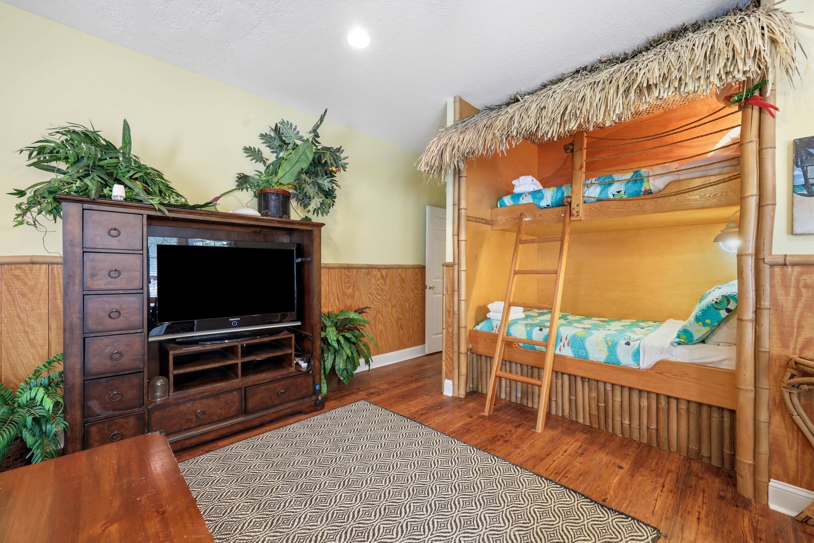 Your island-themed bedroom features a fun tiki-hut bunk bed and tropical touches that'll delight the whole family. Cozy hardwood floors and a TV complete the playful escape.